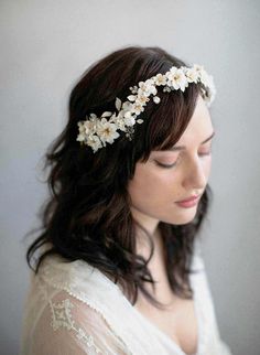 An extravagant bridal headpiece bursting with handmade clay flowers, vintage millinery leaves, Austrian crystals and hand patina painted brass leaves. This headpiece is so intricate and stunning and can be worn as a reverse headpiece or as a headband across the top of your head. Adorned portion measures approximately 13 inches at its longest by 2 3/4 inches at its widest Handmade in our studio Handmade clay flowers Patina pained brass charms Austrian crystals Available in ivory/brass as pictured Vintage Bridal Hair, White Flower Crown, Bridal Floral Headpiece, Bridal Hair Veil, Flower Hair Pieces, Vintage Millinery, Head Dress, Hair Adornments, Bridal Hair Flowers