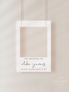 a white photo frame hanging from a string with the words, the wedding of hope and james written on it