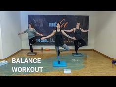 a group of people standing on yoga mats in front of a wall with the words balance workout