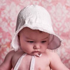 Exquisitely constructed, our classic white bonnet has a flared brim to help shade little faces from the sun. Elastic at back of neck adds a bit of fit. Ties closed to keep bonnet in place. Perfect for the beach, and everyday wear, this lightweight hat is functional and cute. Made in white eyelet embroidered with hearts.• Shell: 100% Cotton, Lining: 65% Cotton, 35% Polyester• Cold handwash, Lay flat to dry• Made in China Baby Bonnet Pattern, White Bonnet, Personalized Baby Hat, Newborn Girl Hat, Girls Hats, Newborn Bonnet, Girls Smocked Dresses, Bonnet Pattern