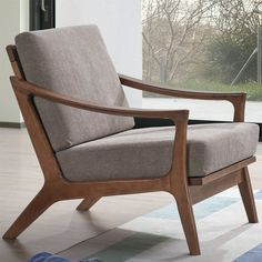 a wooden chair sitting on top of a hard wood floor next to a large window