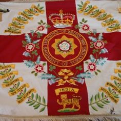 a red and white flag with gold trimmings on the cross, surrounded by other flags