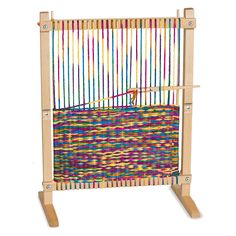 a baby crib that is made out of wood and has multicolored fabric