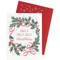 two christmas cards with holly wreaths and pine cones on them, both have red envelopes