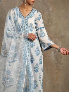 Set of 3 consists of kurta, dupatta and salwar Hand-printed poppies in shades of blue set on an ivory base. Straight v neck, bell sleeve kurta in cotton with hand-made magzi and gota detailing. Salwar- Cotton salwar set in a contrast blue with lehriya gota work Dupatta- Handwoven kota doria, block printed dupatta. Colour - Blue Fabric - Cotton and Kota Doria Occasion - Festive Wear / Occasion Wear Fit - Straight, Relaxed and Comfortable Pattern - Printed Care - Dry Clean only Estimated Delivery Blue Palazzo Set With Printed Motifs And Straight Kurta, Blue Bohemian Kurta With Dupatta, Bohemian Blue Palazzo Set With Printed Motifs, Traditional Blue Floral Print Palazzo Set, Blue Floral Print Dupatta For Navratri, Blue Bohemian Set With Sheer Dupatta, Blue Block Print Mulmul Sets, Blue Mulmul Palazzo Set With Straight Kurta, White Block Print Chanderi Set