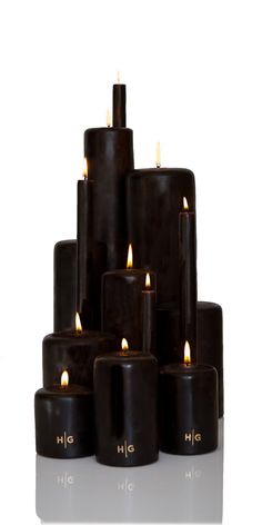 a group of black candles sitting on top of each other