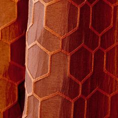 an orange and brown fabric with hexagonal shapes on the back, as seen from below