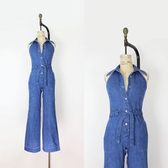 "Vintage 1970s Mushroom brand denim halter jumpsuit. Collared neck and V front with an open back. Silver tone logo snaps down the front with an denim belt at the front waist. Darted bust and fitted waist with two rounded hip pockets. Flared legs and made of a soft and medium cotton denim.  Would best fit an XS / Small  ♦ MEASUREMENTS ♦ Bust - 32\" Waist - to 29\" Hips - 37\" Length - 15.5\" (shoulder to center of waist band) and 42.5\" (center of waist band to hem) Inseam - 33\" Rise - 11.5\" (c Full Length Medium Wash Jumpsuits And Rompers For Summer, Full Length Summer Jumpsuits And Rompers In Medium Wash, Summer Full Length Medium Wash Jumpsuits And Rompers, Summer Full Length Medium Wash Jumpsuit, Vintage Summer Overalls Jumpsuit, Vintage Sleeveless Jumpsuit With Pockets, Vintage Overall Jumpsuits And Rompers, Vintage Sleeveless Overalls For Summer, Vintage Overall-style Jumpsuits And Rompers For Spring