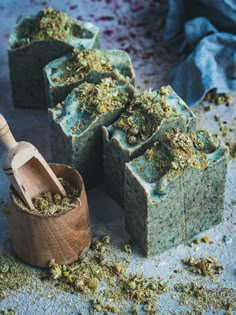 several soaps and a wooden spoon on a table