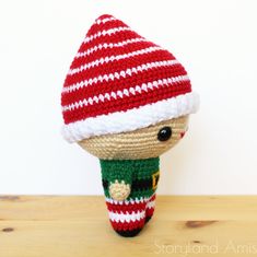 a crocheted stuffed toy wearing a red and white striped hat