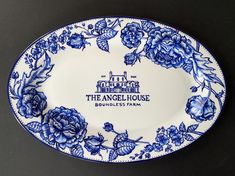 a blue and white plate with flowers on it that says the angel house boutiqueness farm