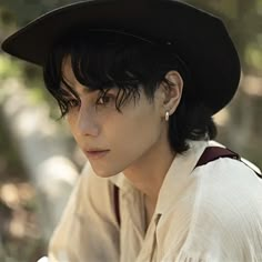 a woman with black hair wearing a hat