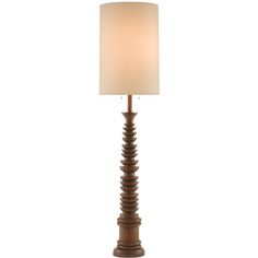 a lamp that is sitting on top of a wooden stand with a white shade over it