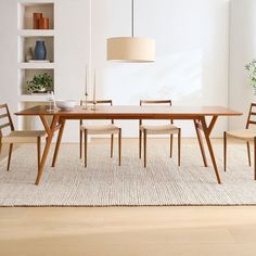 a dining room table with chairs and a lamp