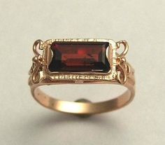 The sky is the limit A rectangular garnet gemstone set in a 14K rose gold ring. The chiseled setting around the gemstone suggests an antique style. RG1400-2. © 2011 Artisanimpact Inc. All rights reserved. Construction & Dimensions: 14k rose gold, garnet Approximately width: 8.5mm (0.33in.) To order sizes 4-12 please convo us or mention the size in your order. About our jewelry Artisanimpact features a variety of brass, silver and 14k gold jewelry. Ancient coins in great settings, Hand stampe Simple Red Engagement Ring, Victorian Style Engagement Ring, Antique Engagement Rings Victorian, Ring Rectangle, Vintage Engagement Ring Settings, Antique Style Rings, January Birthstone Rings, Victorian Engagement Rings, Garnet Engagement Ring