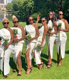 a group of women standing next to each other in white dresses