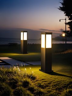 two lights that are sitting in the grass