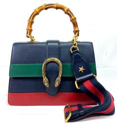 >>FOR SALE<< >>PRE-OWNED<<   Gucci 448075 Dionysus Bamboo Top Handle Colorblock Leather Black/Green/Red Shoulder Bag Bag Sizes - Long - 10.5" Dept - 3" Height - 7.5" Strap Size - 20" + Adjustable Condition - Overall Bag is in a Good Cosmetic Condition! Has Some Sign of Normal Use! Bag Has Few Light but Visible Spots. Strap is in a Great Condition. Strap Has Some Stains on Leather. Interior Has Multiple Stains from Normal Use! Interior is in Acceptable Used Condition! Please Refer to Photos for More Info! ATTENTION: PRE-OWNED WITHOUT TAGS Comes Without Original Box Comes Without Original Dust Bag COMES AS PICTURED PLEASE REVIEW PICTURES FOR CLOSER DETAILS AWESOME DESIGN THIS MODEL WON'T LAST LONG!!! Condition Description: This item is pre-owned. Please refer to pictures for a better underst Gucci Shoulder Bag With Adjustable Strap For Shopping, Gucci Bag With Adjustable Strap For Shopping, Designer Multicolor Shoulder Bag With Adjustable Strap, Green Gucci Bag With Detachable Handle, Gucci Designer Satchel With Detachable Strap, Designer Gucci Satchel With Detachable Strap, Gucci Multicolor Bag For Everyday Use, Gucci Multicolor Shoulder Bag For Daily Use, Gucci Green Crossbody Bag