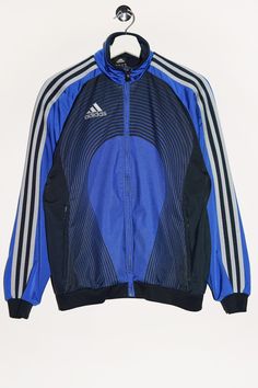 "Vintage Adidas track jacket in blue with a print on the back. - Size tag: Please always check measurements before buying. Youth size L, Fits like Women's S - Measurements (laying flat): Pit to Pit: 21\" Length: 24.5\" Pit to Cuff: 20\" -Wear: /Please see images for details/ Good vintage condition. Fabric snag and burnt spot looking like light stain as shown on the pictures. - Fabric: Polyester *All of our items are preloved pieces so some signs of natural wear and age are to be expected. Please look through the photos carefully to check if the condition is to your satisfaction. *All efforts are made to show any defects however small imperfections may be missed. In cases that we've missed a major flaw, please remember that we are still human and make mistakes, please contact us first so we Blue Track Jacket, Adidas Vintage, Adidas Track Jacket, Adidas Blue, Adidas Track, Vintage Adidas, Light Stain, Blue Adidas, School Fashion