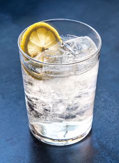 a glass filled with ice and a lemon slice