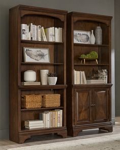 two wooden bookshelves with baskets on each shelf in front of the bookcase