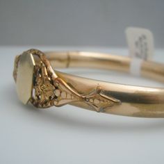 "For sale: (1) d949 Gold Filled 10k Gold Plated 10k Bangle PLEASE READ ENTIRE DESCRIPTION BEFORE PURCHASING Pre-owned item. Good condition. Please see pictures for details. Sold as is, as seen on pictures. The bangle is not stamped, but has been tested for authenticity. Specifics: 10k Gold Filled/Plated Box clasp Length: 8.75 inches Width: 17.5 mm Total Weight: 23 grams Please be 100% sure of your purchase before buying, as we do not offer refunds. We are more than happy to provide any specific Hinged 14k Gold Bracelet, Ornate Yellow Gold Bracelet Jewelry, Gold Oval Bracelet Stamped 14k, Antique 14k Gold Bracelets In Gold, Classic Jewelry Bangle With Intricate Design, Antique 14k Gold Bangle Bracelet, Victorian Filigree Bracelets In Yellow Gold, Classic Bangle With Intricate Design, Antique 14k Gold Bracelets