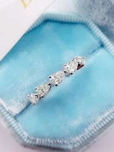 three stone diamond ring in a blue velvet box