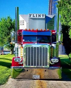 a large semi truck parked on the side of a road