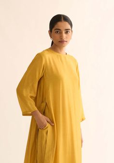 Editor's Note This cotton silk kurta set showcases a stunning mustard color, accentuated by intricate floral bel detailing on the back yoke. The kurta features gather details and high slits, adding a touch of elegance and flair. Paired with straight pants, this ensemble offers a modern and stylish look. Fabric: Kurta & pant: cotton silk, dupatta: organza Color: Mustard yellow Components: Kurta, dupatta and pants Occasion: Festive Disclaimer: Product color may slightly vary due to photographic li Silk Kurta Set, Blouse Yoke, Personal Shopping Service, Pastel Colour Palette, Silk Kurta, Mustard Color, Kurta With Pants, Silk Dupatta, Kurta Set