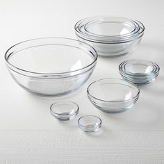 clear glass bowls and plates on a white surface