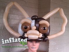 an inflatable animal head is on top of a mannequin's head