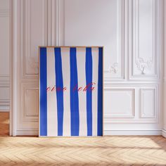 a blue and white striped wall hanging in an empty room with the word love on it