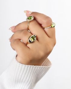 Bold, beautiful, and undeniably boss - packed with a punch of peridot that's as sunny as your disposition, the Dayglow Ring is ready to add a dash of glow to your everyday ensemble. Whether you're conquering the world or simply conquering your coffee, this ring is your go-to glow-up. Slip it on and let the compliments roll in. Your jewelry is designed to last a lifetime, but keep in mind that they are still made from precious metals and delicate stones. While our jewelry pieces can be worn every Fine Jewelry Lime Green Diamond, Fine Jewelry With Lime Green Diamond, Lime Green Diamond Ring Gift, Lime Green Diamond Rings For Gift, Yellow Gold Peridot Jewelry With Halo Setting, Lime Green Diamond Rings For Gifts, Green Peridot Stackable Rings, Peridot Ring Jewelry, Lime Green Gemstone Ring Jewelry