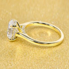 a yellow gold ring with two diamonds on it's shants, set against a golden background