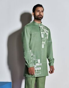 HAND EMBROIDERED SHORT KURTA WITH CONTRAST STITCH DETAILS. LOOKS BEST PAIRED WITH MATCHING TROUSERS.THIS PRODUCT IS HAND EMBROIDERED USING 'AARI' CHAINSTITCH EMBROIDERY, SEQUINS AND GLASS BEADS.MODEL CHEST 40’', WEARING SIZE M, HEIGHT 6'NO. OF GARMENTS: 1 Fitted Embroidered Shantoon Kurta, Semi-stitched Shantoon Kurta With Intricate Embroidery, Embroidery On Mens Kurta, Semi-stitched Green Embroidered Straight Kurta Fabric, Semi-stitched Embroidered Shantoon Kurta, Chain Stitch Embroidery, Embroidered Shorts, Contrast Stitch, Chain Stitch