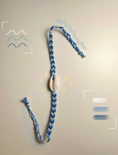 a blue and white rope with a bead on it next to an eraser