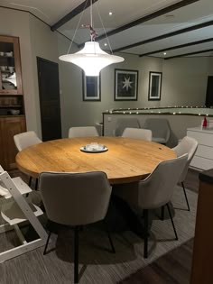 a large wooden table surrounded by white chairs