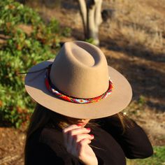 Price includes a Lola Sambboho hat & a Red Vogue hatband. Save 10% with this bundle. Select hat size. Hatband is one size fits all. Hatband is removable. An iconic must-have Fedora hat that will never get out of fashion. Sambboho's Lola hat has a soft brim and indented crown. A chic piece to be worn at all seasons of the year. The timelessness chic and sophistication exuded by this hat make it a lifetime wardrobe investment you’ll never regret! Classic Fedora design in Sand color Trimmed wit Red Vogue, Never Regret, Seasons Of The Year, Sand Color, Hat Band, Fedora Hat, Hat Making, Hat Sizes, All Seasons