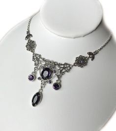 This lovely necklace is made with antiqued silver plated filigrees, adorned with dazzling DEEP VIOLET PURPLE glass rhinestones and jewels. Decorated portion measures 5" wide and 2 1/8" tall in the center. It is adjustable 15" to 18" in length and fastens with a lobster clasp.This is available in a variety of stone colors in our store, along with matching earrings and headpieces. If you don't see something with the stone color you'd like, feel free to send us a message. Victorian Jewelry Necklace, Goth Victorian, Dark Amethyst, Agatha Harkness, Victorian Jewellery, Victorian Necklace, Choker Pendant, Goth Jewelry, Purple Jewelry