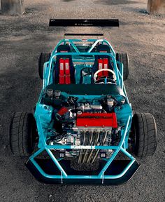 an engine in the back of a blue race car with red and white piping