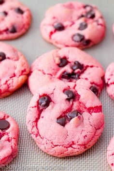 chocolate chip cookies with pink icing and red sprinkles