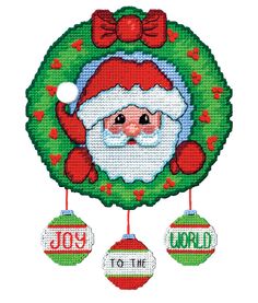 a cross stitch christmas ornament with santa claus