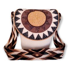 Introducing the O'ULAA Wayuu Mochila Bag, a unique, handmade bag from Colombia. Crafted with intricate detail and skill, this beautiful bag is made using traditional Colombian weaving techniques that have been passed down for generations. Featuring an eye-catching combination of sand, brown, black and chocolate colors in a classic mochila design with flap closure for added security. This gorgeous bag offers both style and practicality - perfect for any occasion! Each one is truly one-of-a-kind; no two bags are the same so you can be sure to stand out from the crowd. Show off your style while supporting local artisans by adding the O'ULAA Wayuu Mochila Bag to your wardrobe today! Features & Benefits: Height of WAYUU Mochila Bag: 11 in, Base of WAYUU Mochila Bag: 8 in, Strap Length of WAYUU Mochila Bag, Chocolate Color, Handmade Bag, Gorgeous Bags, Local Artisans, Weaving Techniques, Beautiful Bags, Handmade Bags, Cross Body Handbags