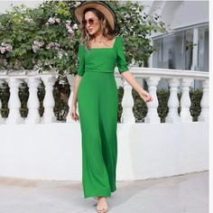 New Green Square Neck Short Sleeve Wide Leg Pant Jumpsuit This Womens Jumpsuits Features A Classic Square Neckline Adding A Touch Of Sophistication And Elegance To The Jumpsuit, Creating A Three-Dimensional And Layered Look That Is Sure To Turn Heads, While The Ruched Bodice Adds A Touch Of Glamour And Accentuates Your Curves. It's A Timeless Piece That Will Make You Stand Out. Wide Flowy Leg Short Sleeves Zipper Back Square Neckline Polyester And Elastane Size Large New Without Tags Fitted Wide Leg Jumpsuit Or Romper In Solid Color, Elegant Green Jumpsuits And Rompers For Beach, Elegant Green Beach Jumpsuits And Rompers, High-waisted Green Jumpsuits And Rompers For Summer, Green High-waist Jumpsuits And Rompers For Summer, High Waist Green Jumpsuits And Rompers For Summer, High Waist Solid Jumpsuits And Rompers For Summer, Elegant Short Sleeve Jumpsuits And Rompers For Vacation, Elegant Solid Color Summer Jumpsuits And Rompers