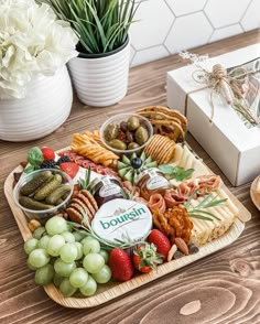 an assortment of snacks on a wooden tray