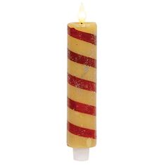 a red and yellow striped candle is lit