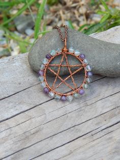 Rainbow fluorite pentacle necklace, this copper wire wrap pendant would be the perfect addition to your witchy jewelry collection or give it as a unique gift under 30! On this witchy pendant lovely green/purple rainbow fluorite beads are wrapped with recycled copper wire onto a sturdy copper frame, in the middle a copper pentacle is formed out of the same copper wire and it has been given a light gun-blue patina. The total length of this wire wrapped pendant is 1 3/4" inches from top tip of bail Witchy Wire Wrapped Jewelry, Christmas Wire Wrapped Jewelry, Halloween Wire Wrap, Wire Wrapped Jewelry Beginner, Witchy Pendant, Pentacle Jewelry, Copper Wire Crafts, Pentacle Necklace, Wire Creations