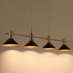 three lights hanging from the ceiling in a room