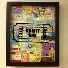 a black frame with an admt one tag on it in front of a wall