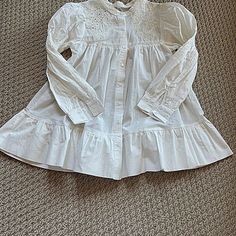 Cute Long Sleeve Baby Doll Style White Cotton Blouse/Top/Tunic. Size Xs. New Without Tags. Never Worn. Purchased Directly From Shein But Decided It Is Just Not My Style. Embroidery And Cutout Work With Puffy Sleeves. Gathered At Pit And Ruffled Again At Bottom Of Top. Buttons Down The Front. Band Sleeves With Smocking On Sleeve To Make Sleeve At Shoulder A Puffy Appearance. No Odors, Pulls, Pilling, Stains Or Any Other Flaws. Measurements: Length: 27 Inches Pit To Pit: 15 Inches Shoulder Seam To Flower Cut Out, Tops Shein, Cutout Blouse, White Cotton Blouse, Tøp Aesthetic, Aesthetic Fits, Puffy Sleeves, Shein Tops, Cotton Blouse